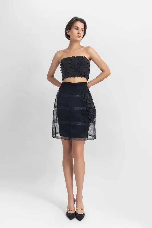 Strapless cropped-top with laser-cut details, paired with a cage-like skirt with flower details
 on the side. lace skirt delicate